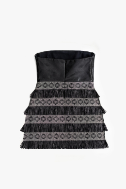 Mini cocktail dress in black nappa leather. Designer strapless mini dress featuring a corset bodice and raffia-ornamented skirt.